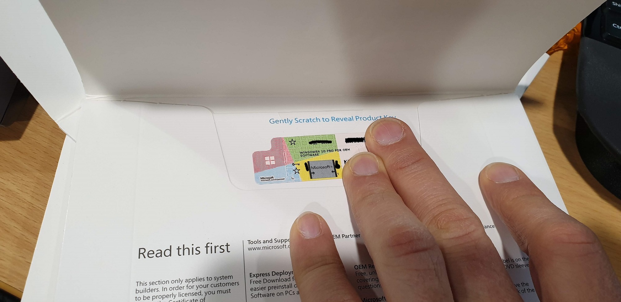 'Gently scratch to reveal product key' isn't scratchable on Windows 10 licence pink tape -... ec2f285a-cf31-4156-b2e4-e49fc69a3baa?upload=true.jpg
